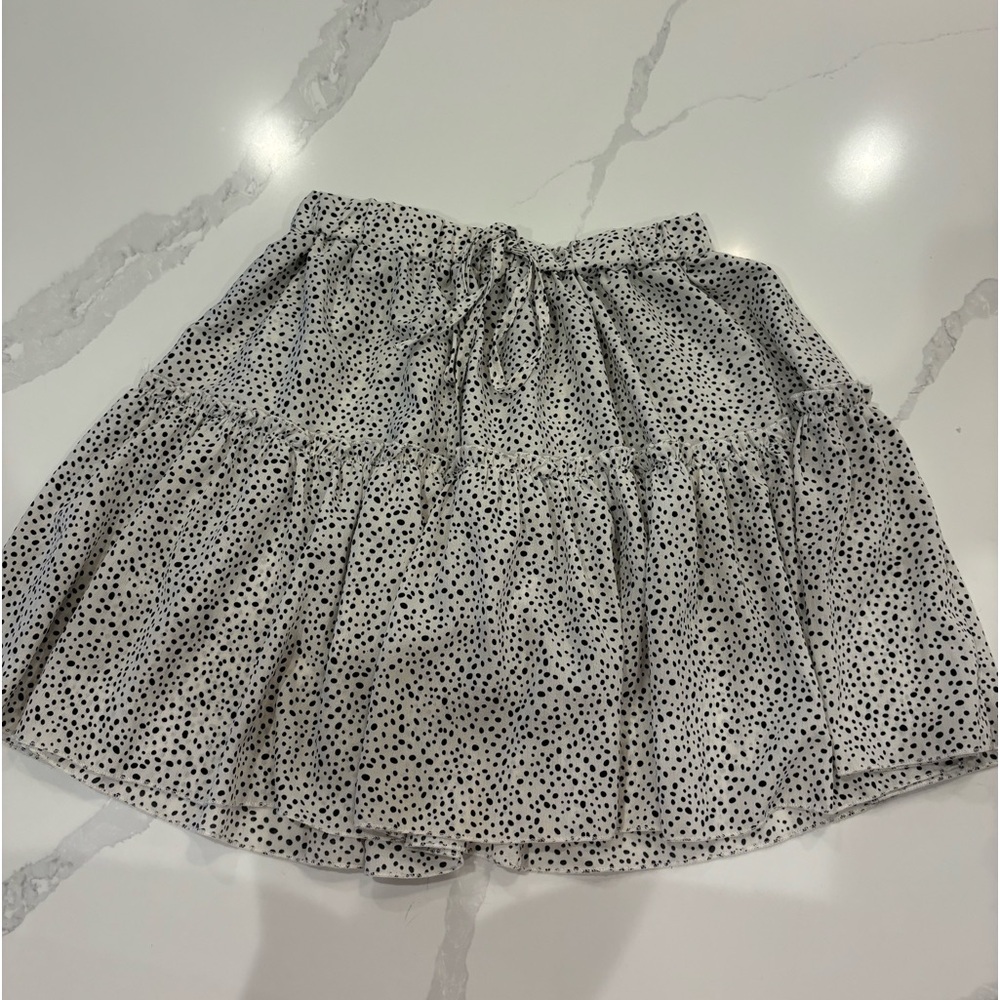 White skirt with black polkadots.